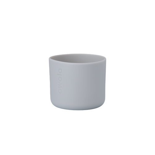 Owala Bottle Boot in soft light gray silicone with tonal Owala logo, short cylindrical form sized for 16oz Kids' FreeSip bottles