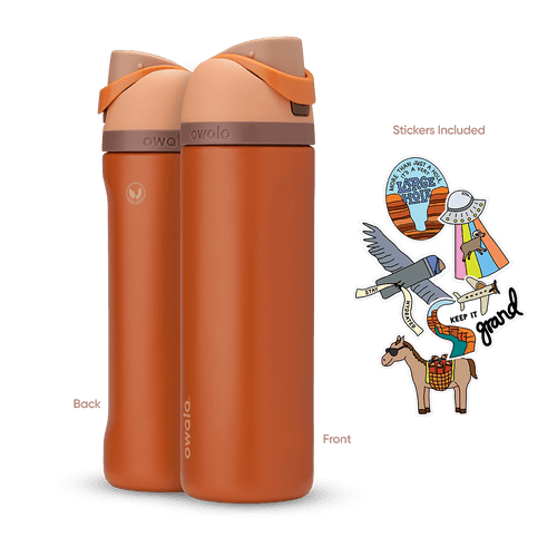 Great American Road Trip FreeSip 24oz in Grand Canyon, warm terracotta-orange body with peach flip cap, mauve carry loop, and brown lid accent band; back and front views shown with included national park-themed stickers featuring an eagle, horse, UFO, and "Keep It Grand" rainbow