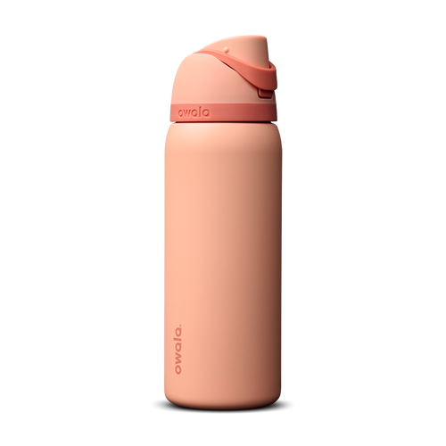 Owala FreeSip 32oz in Peach of Mind, soft coral peach insulated bottle with matching peach flip cap and carry loop